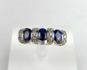 Silver ring with blue gemstones and diamonds.