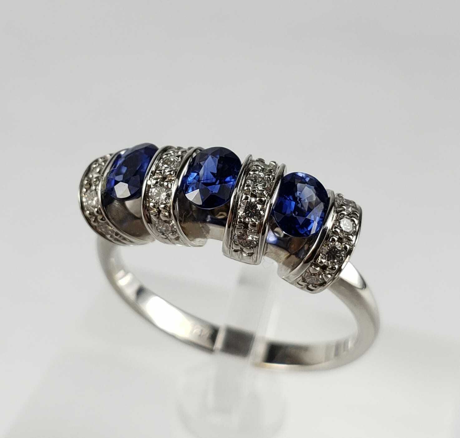 Silver ring with blue gemstones and diamonds.