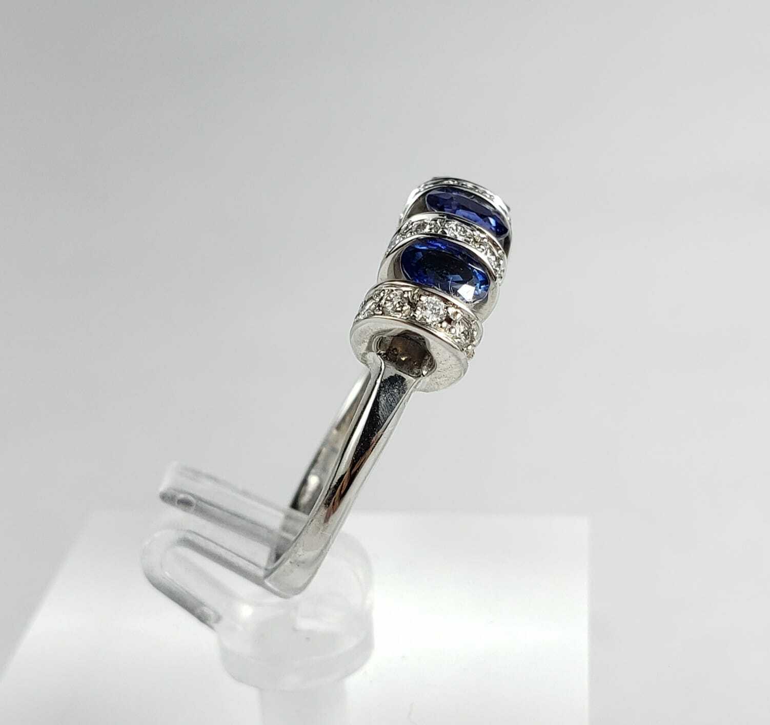 Silver ring with blue gemstones and diamonds.