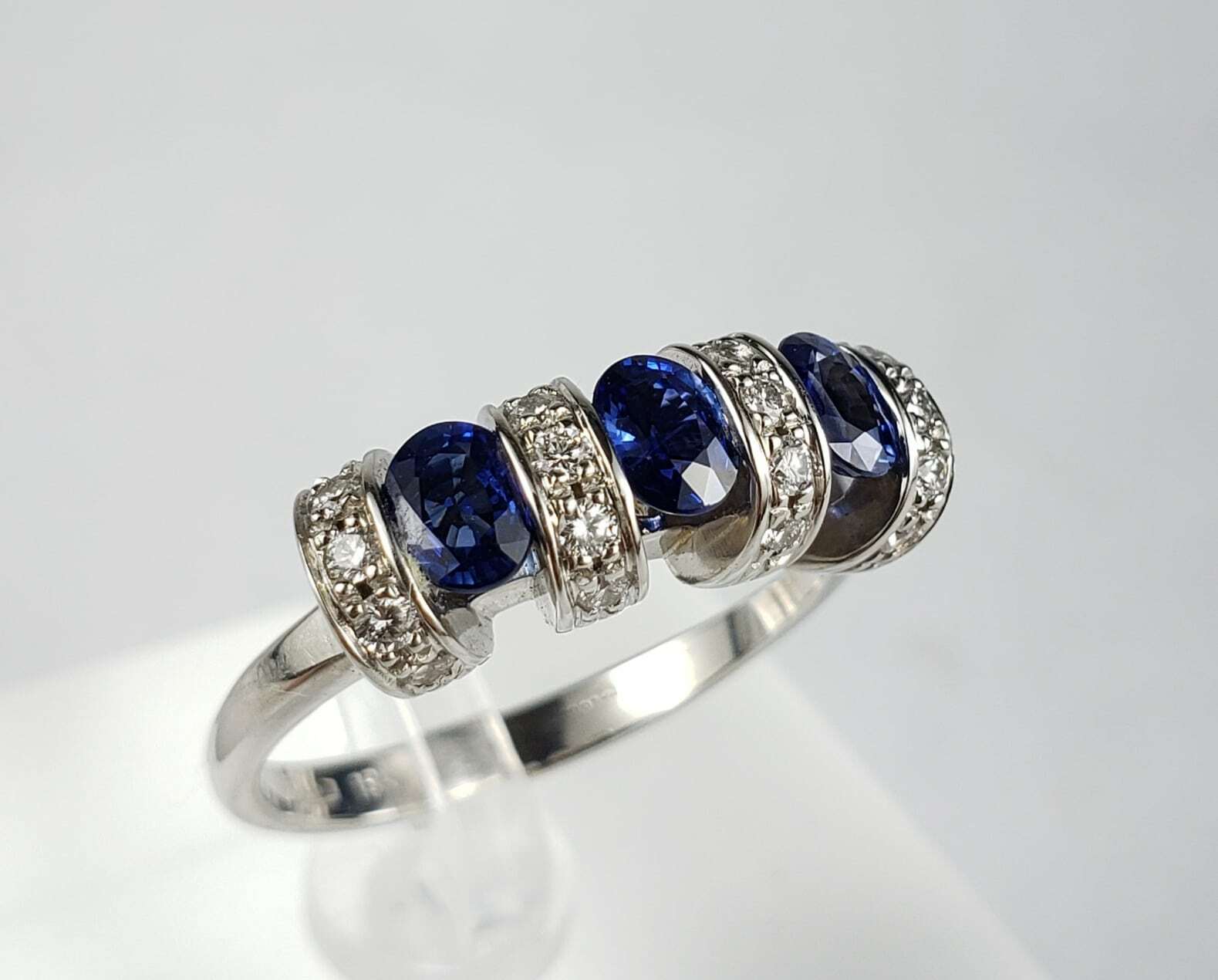 Silver ring with blue and clear stones.