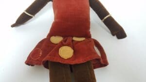 Vintage cloth doll with a red dress.