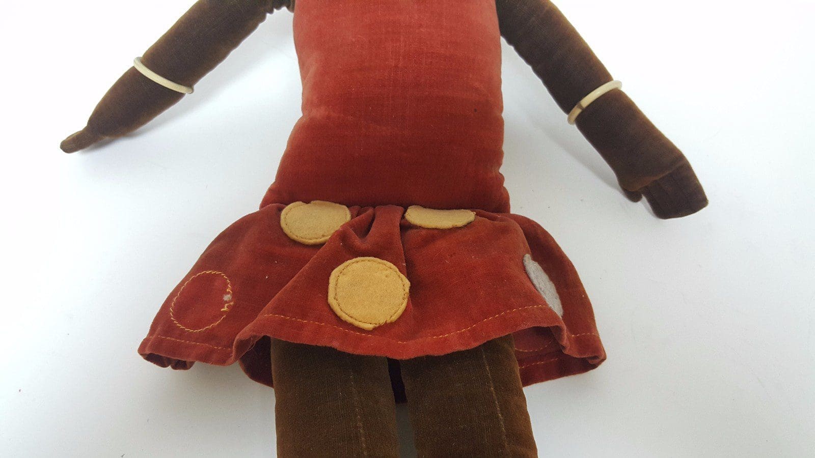Vintage cloth doll with a red dress.