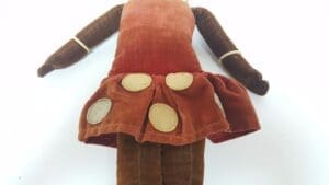 Vintage doll with brown dress and dots.