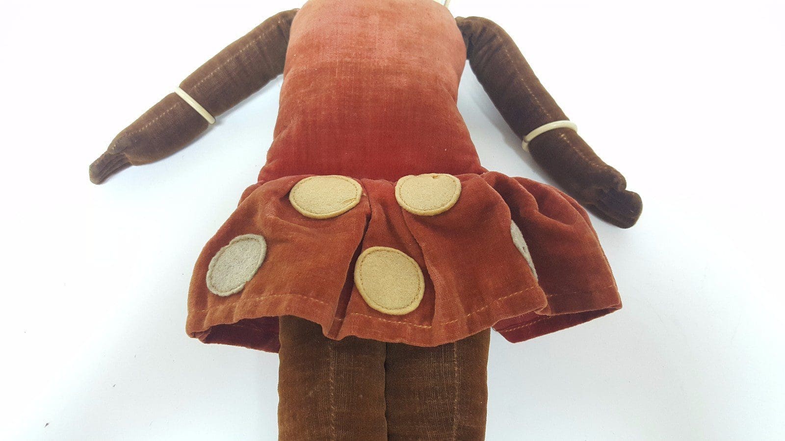 Vintage doll with brown dress and dots.