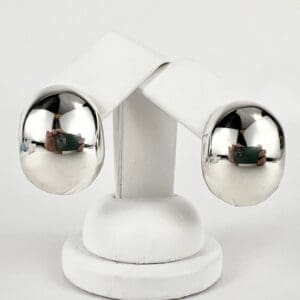 Two reflective metal spheres on white stand.