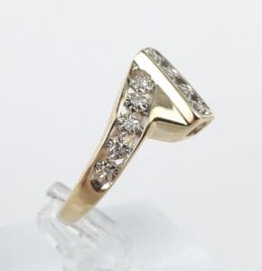 Gold ring with embedded diamonds, side view.