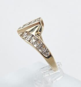 Gold ring with angled diamond design.