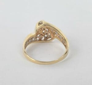 Gold ring with intricate heart design.