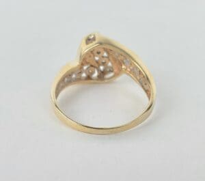 Gold ring with intricate cutout design.