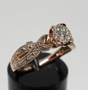 Rose gold ring with diamond centerpiece.