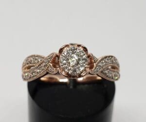 Rose gold ring with diamond cluster design.