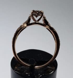 Rose gold ring with heart-shaped setting.