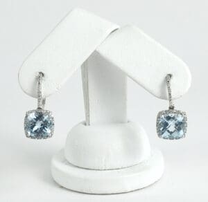 Silver earrings with blue gemstones on display.