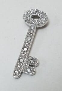Silver key with decorative rhinestones.