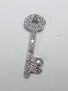 Silver decorative key with rhinestones.