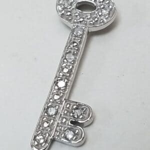 Silver key with decorative rhinestones.