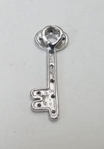 Silver vintage-style key on white background.