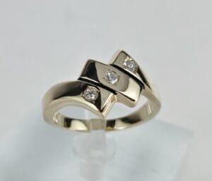 Gold ring with diamond accents on display.