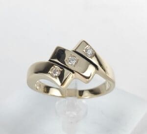 Gold ring with three diamond accents.