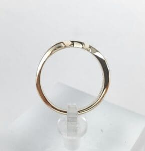 Gold ring with a textured design.