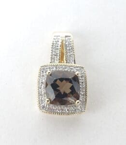 Square gemstone pendant with diamond accents.