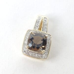 Gold pendant with square brown gemstone.