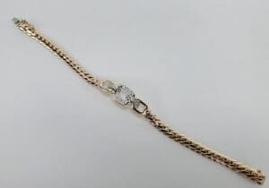 Gold bracelet with diamond centerpiece.
