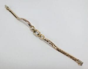Gold bracelet with interlocking links design.