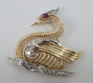 Gold and silver bird-shaped brooch.