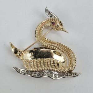 Gold dragon-shaped brooch with gemstones.