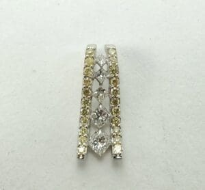 Diamond-studded earring with yellow accents.