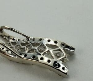 Silver jewelry piece with geometric design.