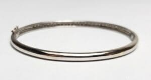 Silver bangle bracelet on white background.