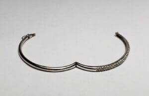Silver bracelet with crystal accents on display.