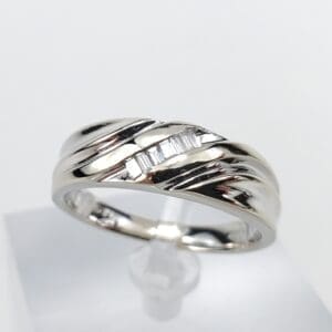 Silver ring with geometric design on display.