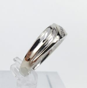 Silver ring with subtle engraved design.