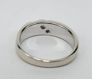 Silver ring with two small stones inside.
