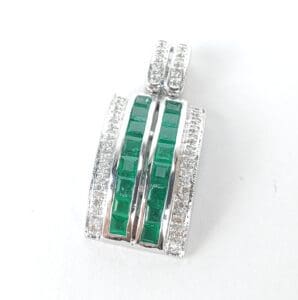 Silver pendant with green gemstones and diamonds.