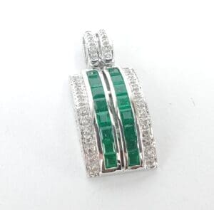 Silver pendant with green and clear stones.