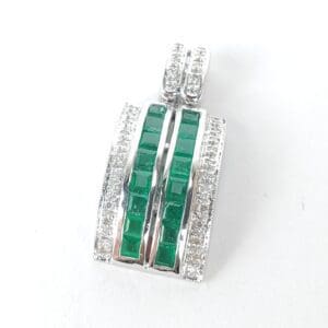 Silver pendant with green gemstones and diamonds.