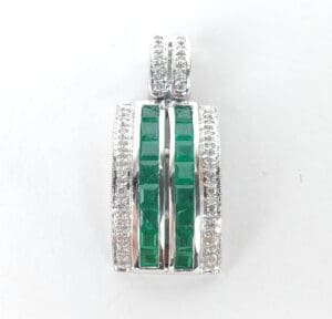 Silver pendant with green gemstones and diamonds.