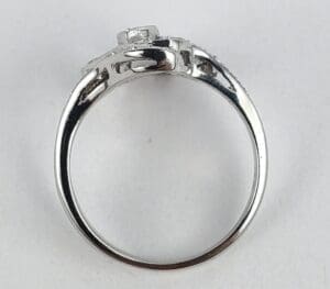 Silver ring with square-shaped gemstone setting.