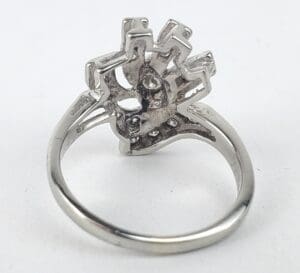 Silver ring with intricate geometric design.