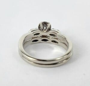 Silver engagement ring with intricate design.