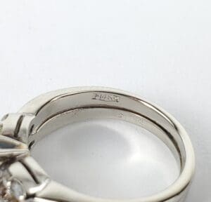 Silver ring with engraved text inside band.