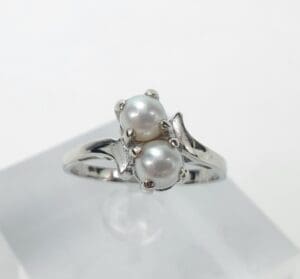 Silver ring with two white pearls.