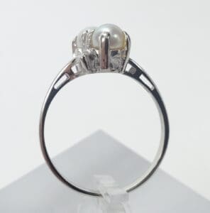 Silver ring with pearl adornment.