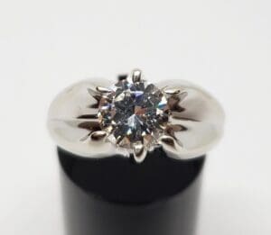 Silver ring with large central diamond.