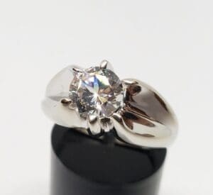Silver ring with a large round diamond.