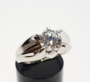 Silver ring with large round diamond.